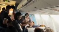 Moment female plane passenger throws her drink at stewardess before tossing her wig and attacking other travellers