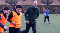 Prince William enjoys a football game during visit to youth hub in Toxteth - and makes a light-hearted joke about his skills