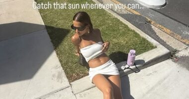 Rita Ora wowed in a white two-piece as she sunbathed on the pavement during her New Zealand holiday in an Instagram post on Tuesday