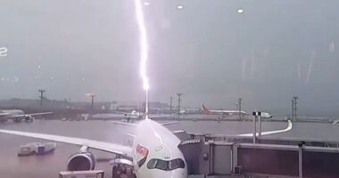 Watch as British Airways plane is struck by lightning & cars are swept away as devastating floods wreak havoc in Brazil