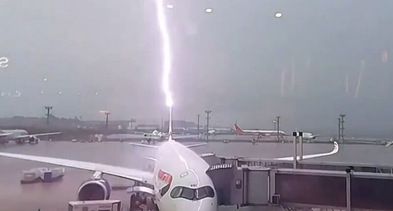 Watch as British Airways plane is struck by lightning & cars are swept away as devastating floods wreak havoc in Brazil