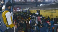 At least 18 people killed in stampede at station as thousands push to board train on way to Indian religious festival