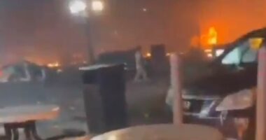 Blood-curdling cries as flaming debris rains down around children outside Dunkin' after plane crash