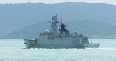 China flexes its military muscles as warships sail close to Australia in 'unprecedented' move of aggression while Beijing navy chopper buzzes within TEN FEET of Philippines coastguard plane