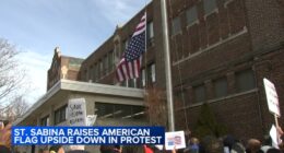 Father Michael Pfleger flies American flag upside-down outside Saint Sabina Church in Gresham, Chicago