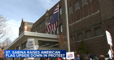 Father Michael Pfleger flies American flag upside-down outside Saint Sabina Church in Gresham, Chicago