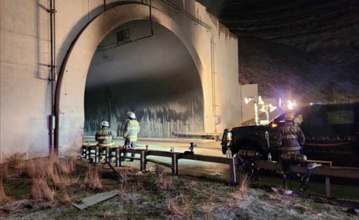 Investigators enter a highway tunnel in Wyoming where a fiery crash killed 2