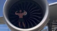 Shock moment bodybuilder influencer climbs into plane’s ENGINE to flex muscles and do push-ups in hugely dangerous stunt