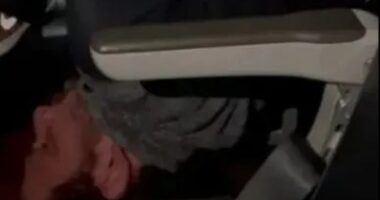 Shocking moment passenger is pinned down by flyers and tied up with shoelaces after SMASHING plane window