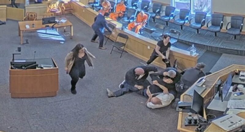 Video captures courtroom brawl as two men attack murder suspect during hearing