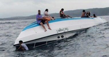 Passengers sit on a boat carrying tourists including a number of Australians that capsized in the waters off Nusa Penida Island, in Bali.