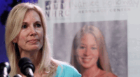 Beth Holloway makes a statement from a microphone