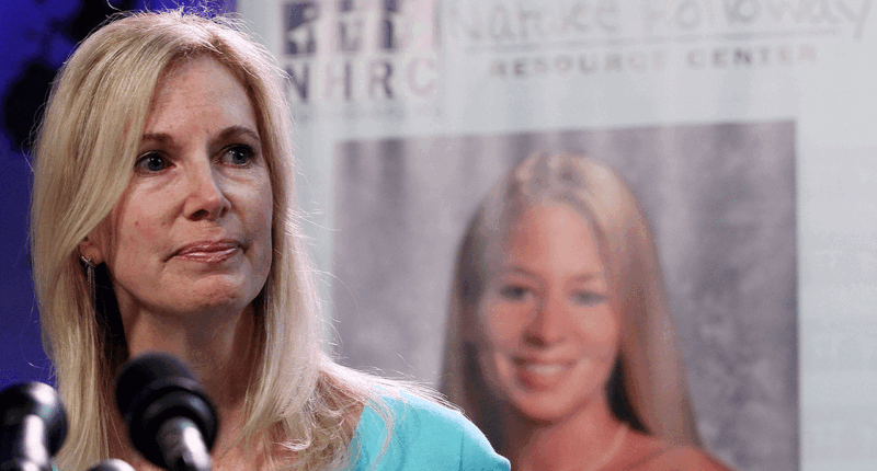 Beth Holloway makes a statement from a microphone