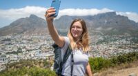 Cape Town becomes new anti-tourism flash point as activists condemn rise of selfie-taking digital nomads and holidaymakers are told 'stop coming to South Africa'