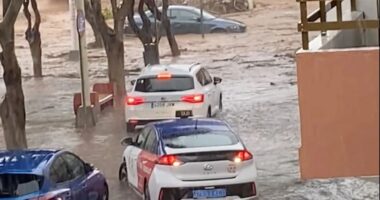 European holiday hot spot ravaged by flash floods as cars washed away and tourists warned to stay indoors