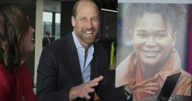 Prince William appears in cheerful spirits as he fires up a laptop during visit to a mental health charity close to his and Kate Middleton's hearts