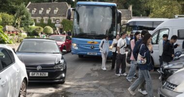 Tourist invasion of 'England's most beautiful village' could see coaches BANNED after families lose patience with the thousands of visitors