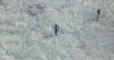 Watch bizarre moment Russian soldiers ride into battle on E-SCOOTERS before being blown up by Ukrainian drone