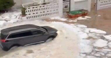 Watch moment Spanish holiday hotspot is flooded by river of ICE after hail storm as torrential rain batters region