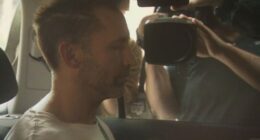 Robert Crawford was seen in the back seat of a police car as he was brought into Ipswich Police Station.