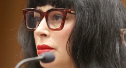 Weezer bassist's wife cleans up her style act for first court date after being shot by cops