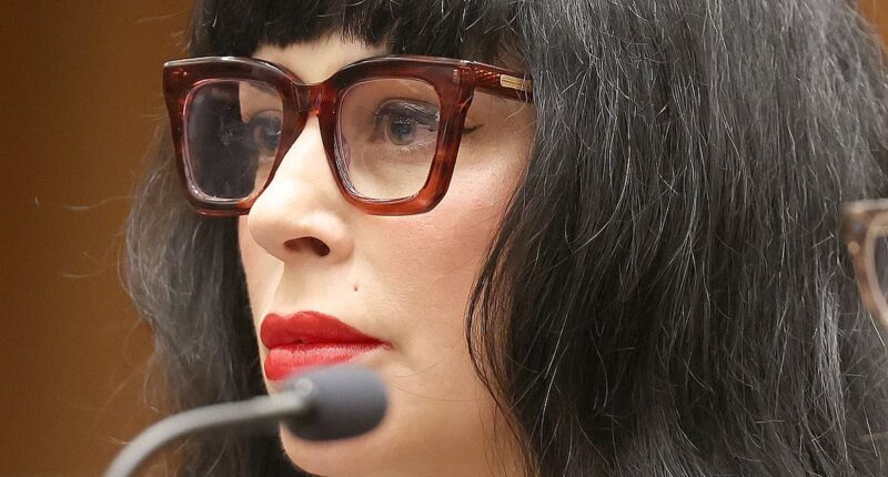 Weezer bassist's wife cleans up her style act for first court date after being shot by cops