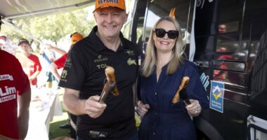 Prime Minister Anthony Albanese with partner Jodie Haydon with some sausages in Perth.