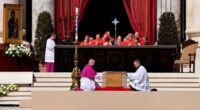 26 April 2025, Vatican, Vatikanstadt: Archbishop Diego Giovanni Ravelli (front, l) kneels next to the closed coffin at the funeral mass for the late Pope Francis in St. Peter's Square. Photo: Oliver Weiken/dpa (Photo by Oliver Weiken/picture alliance via Getty Images)