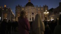 People gather in St Peter's Square as they wait to see the smoke billow from the chimney of the Sistine Chapel in St Peter's Square during the cardinals' conclave to elect a new pope, at the Vatican, Wednesday, May 7, 2025.