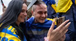 Homecoming Ukrainian soldiers are embraced by families after latest prisoner exchange with Russia - hours after Putin's army launched huge drone attack