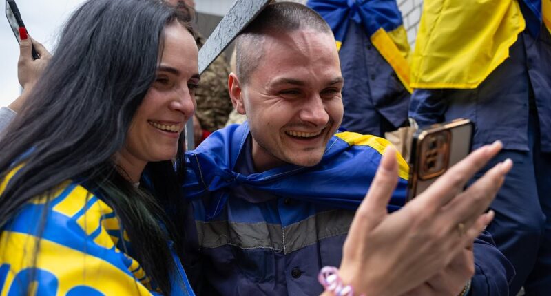 Homecoming Ukrainian soldiers are embraced by families after latest prisoner exchange with Russia - hours after Putin's army launched huge drone attack