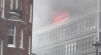 Huge fire rips through London tower block with flats engulfed in flames as 75 firefighters scrambled