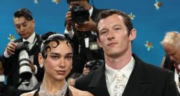 Met Gala 2025: Dua Lipa stuns in a dramatic feathered mini dress as she makes rare appearance with fiancé Callum while leading the British and Irish stars on the blue carpet