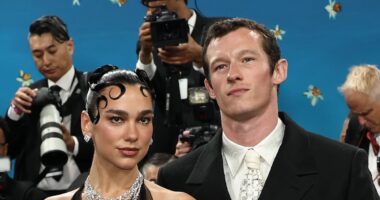 Met Gala 2025: Dua Lipa stuns in a dramatic feathered mini dress as she makes rare appearance with fiancé Callum while leading the British and Irish stars on the blue carpet