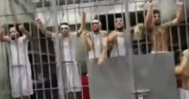Moment deported Tren de Aragua gang inmates scream and rattle cells at US officials in notorious El Salvador mega-prison
