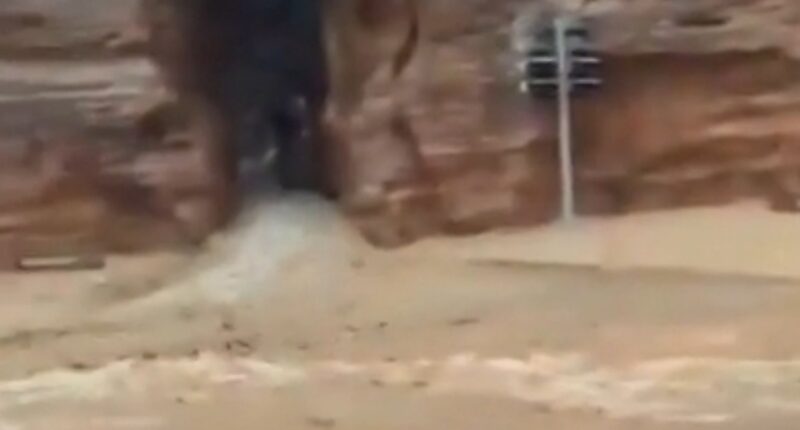 Mum and son found dead after flash flooding in tourist hotspot as hundreds are evacuated