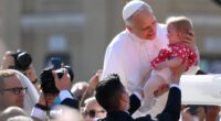 Pope Leo holds baby & waves to crowds in St Peter’s Square as world leaders gather for Pontiff’s inauguration mass