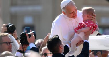 Pope Leo holds baby & waves to crowds in St Peter’s Square as world leaders gather for Pontiff’s inauguration mass
