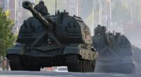 Putin and President Xi watch Russia's Victory Day Parade in Moscow as Ukraine says it 'cannot guarantee the safety' of those attending - and experts warn of WW3 'in one year'