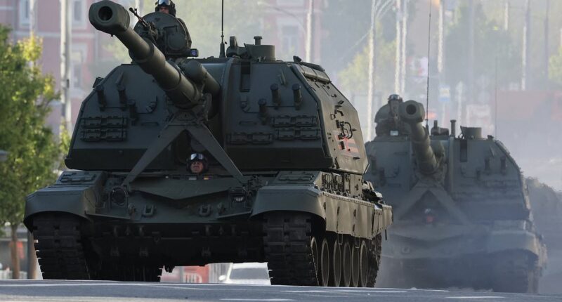 Putin and President Xi watch Russia's Victory Day Parade in Moscow as Ukraine says it 'cannot guarantee the safety' of those attending - and experts warn of WW3 'in one year'