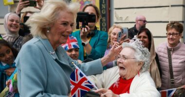Sweet moment Queen Camilla is greeted by an excited supporter in Bradford as King Charles is wowed by famous magician's tricks