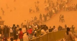 Terrifying moment apocalyptic SANDSTORM engulfs 10,000 tourists leaving air thick with orange dust sparking evacuations