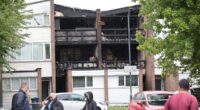 Three children aged four, eight and 15 and 43-year-old woman are killed in house fire as police arrest man