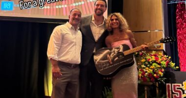 Travis Kelce poses with fans who bought stunning Taylor Swift merch at Patrick Mahomes' charity event