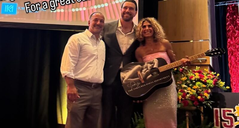 Travis Kelce poses with fans who bought stunning Taylor Swift merch at Patrick Mahomes' charity event
