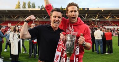 Wrexham co-owners Rob McElhenney and Ryan Reynolds celebrate with the League One trophy