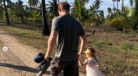 'Daddy's little girl': Meghan Markle shares more unseen snaps of Lilibet on her fourth birthday showing Prince Harry cradling her in his arms and walking together hand-in-hand