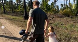 'Daddy's little girl': Meghan Markle shares more unseen snaps of Lilibet on her fourth birthday showing Prince Harry cradling her in his arms and walking together hand-in-hand