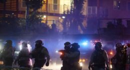 After tear gas and street fires, an Los Angeles community cleans up as National Guard troops arrive