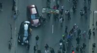 Car drives through anti-ICE protesters as Chicago joins nationwide anti-ICE unrest amid Trump crackdown